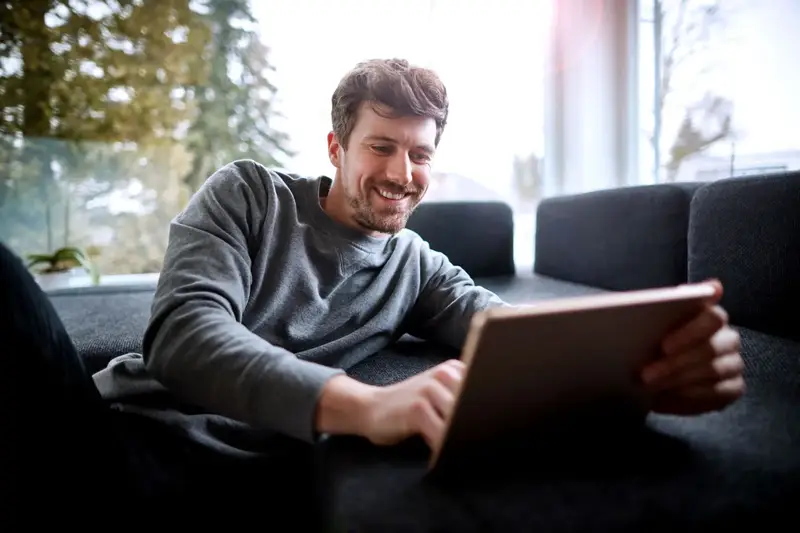 Man on the sofa using his laptop