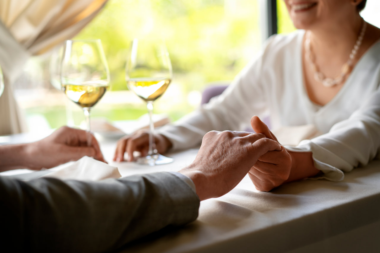 A couple holding hands across a restaurant table
