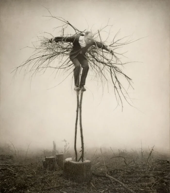 Man propped up like a tree or a scarecrow unique photography.jpeg