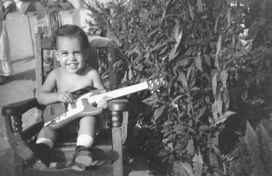 Frank Suarez as a small child playing guitar.jpg