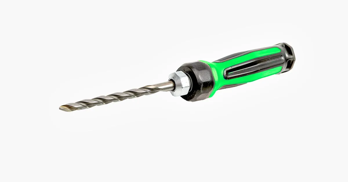 Close-up of a green and black combination drill bit and screwdriver tool on a light gray background