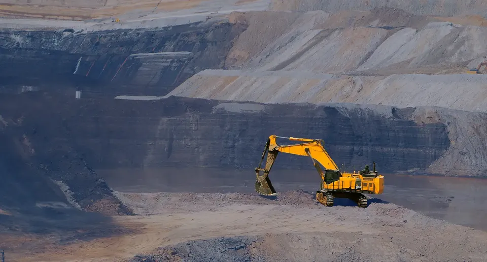 An excavator working in an open-pit mine