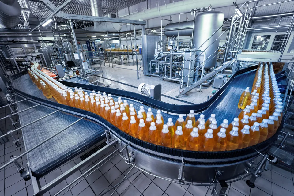 Bottles running along a curved production line