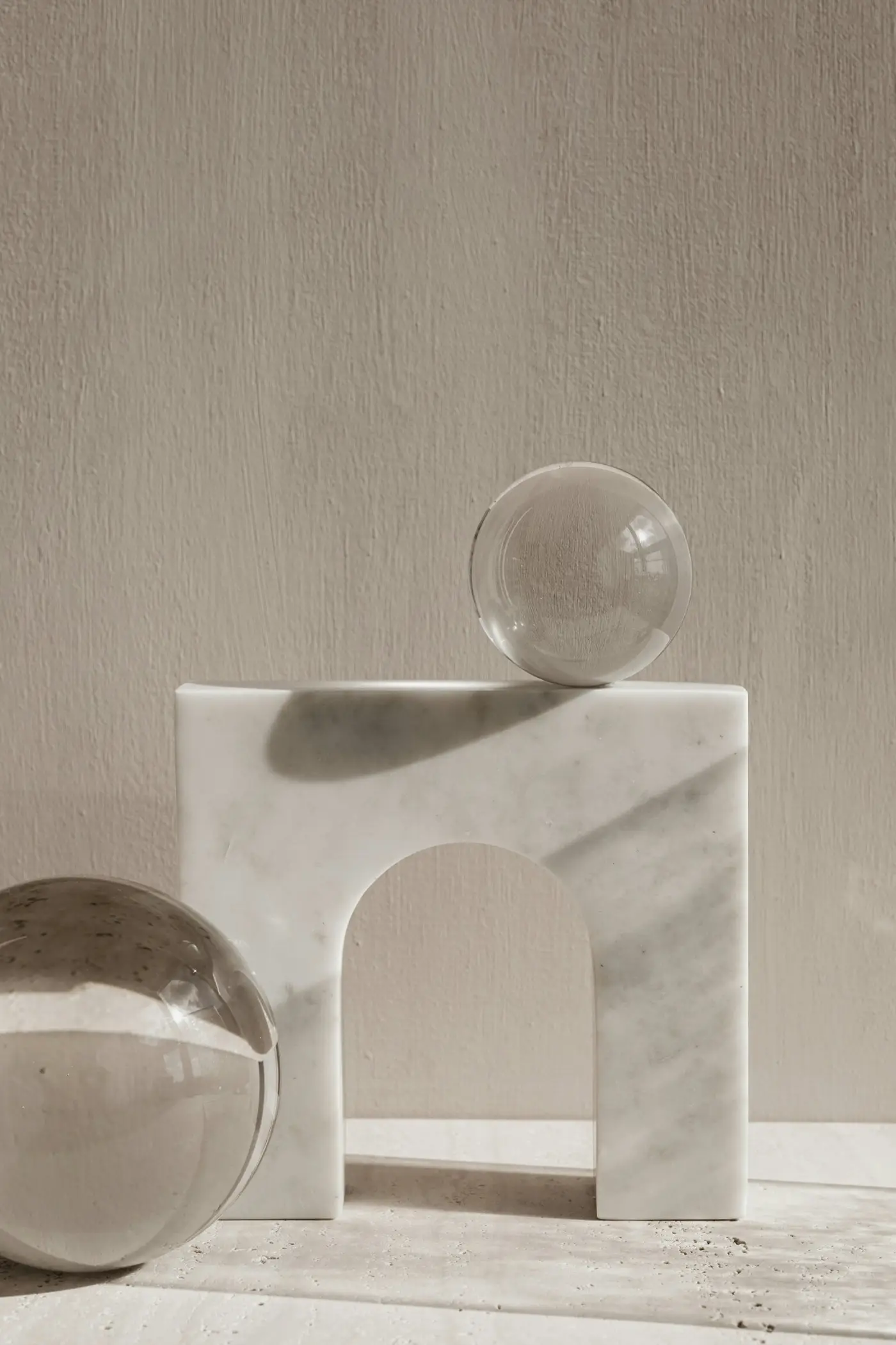 Marble archway and glass spheres in soft natural light