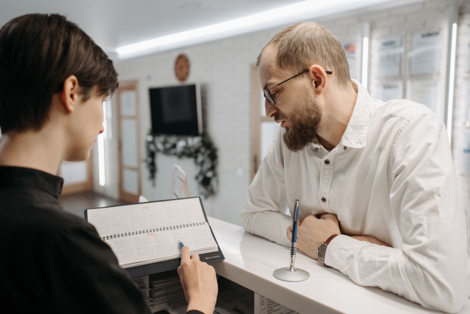 Receptionist booking a client appointment at the front desk