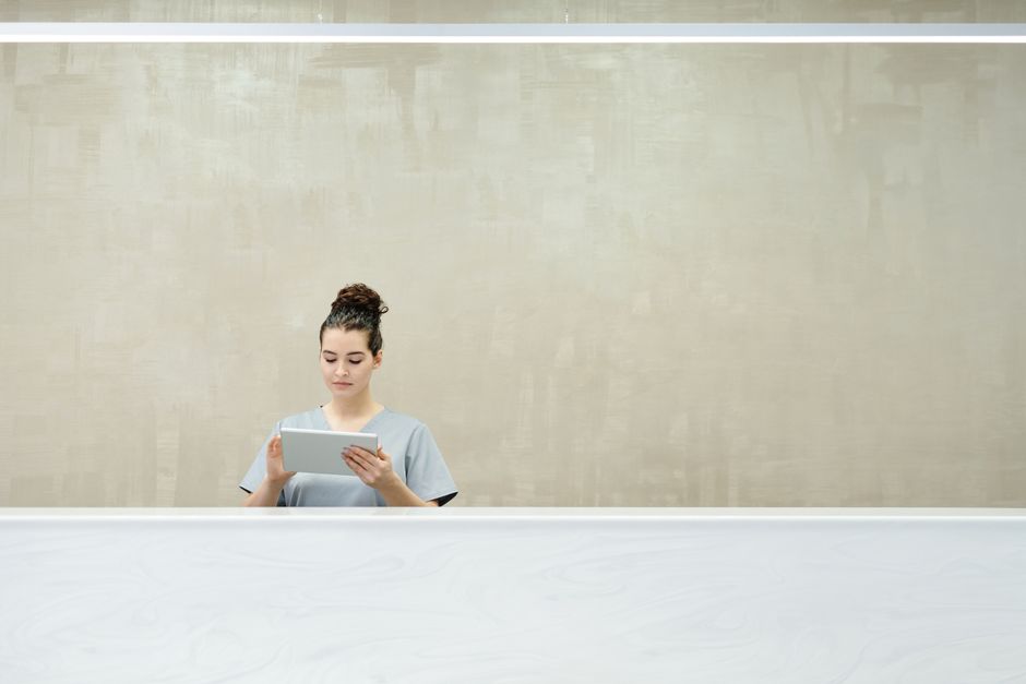 Front desk staff using a tablet to manage client records