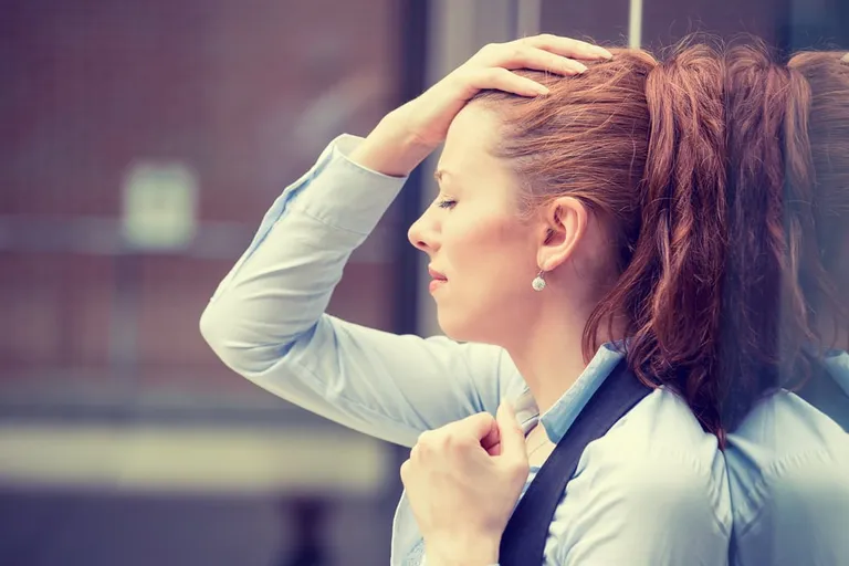Stressed young woman outdoors with city urban lifestyle