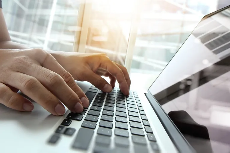 Employee using laptop with analytics dashboard concept