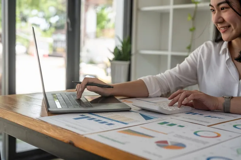 Manager preparing payroll on a computer