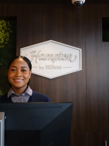 Receptionist at the Hampton by Hilton front desk