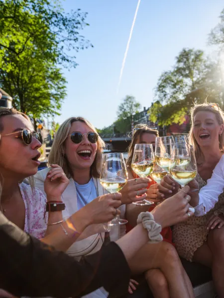 Friends toasting on a canal boat with The Fun Group