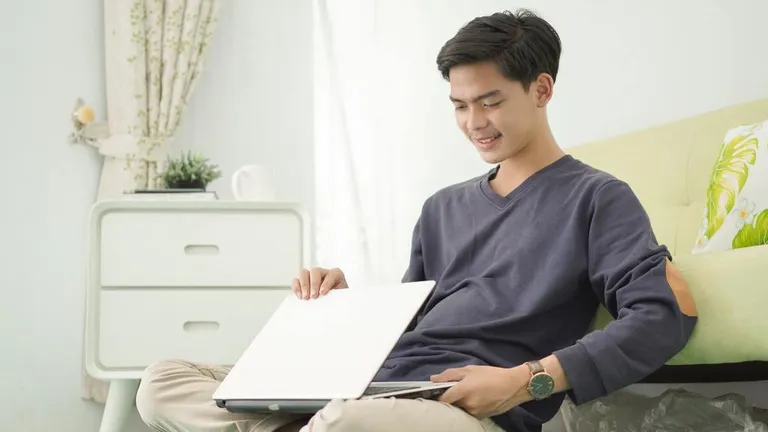 Employee turning off laptop after work