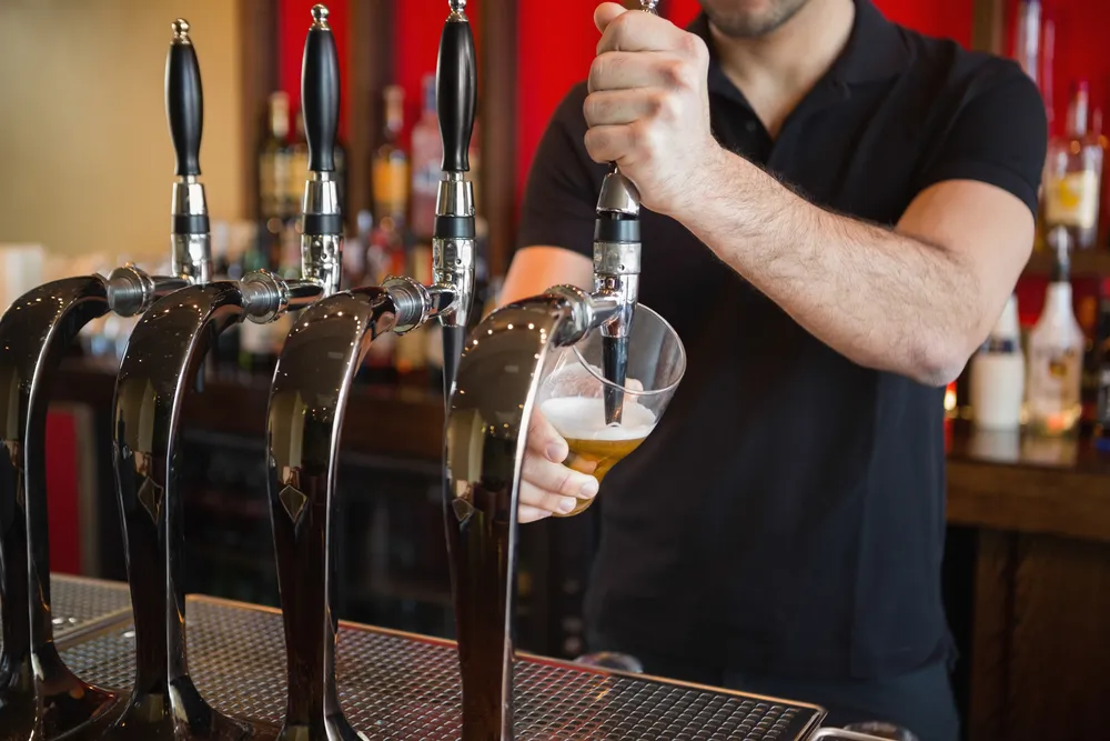 barkeeper tapping beer