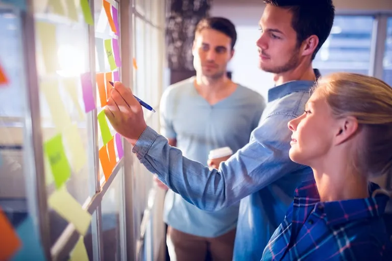 team working on board with sticky notes