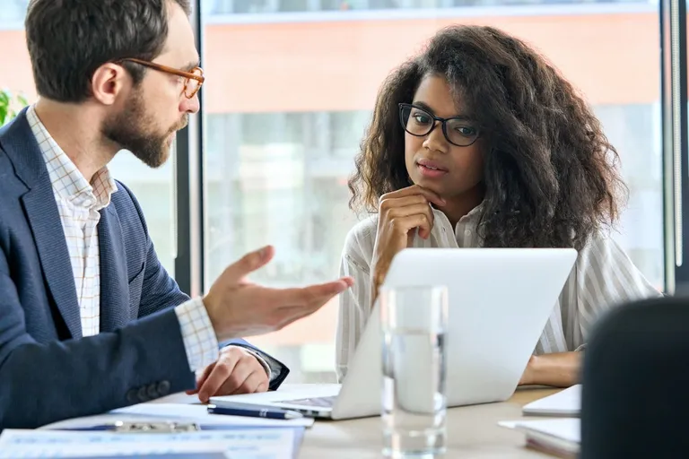 Manager coaching trainee in a meeting