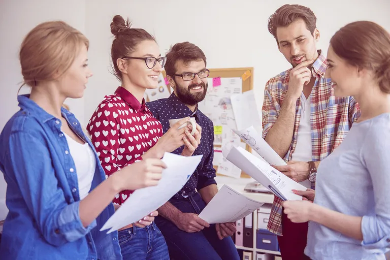Team collaborating in office (employee well-being)
