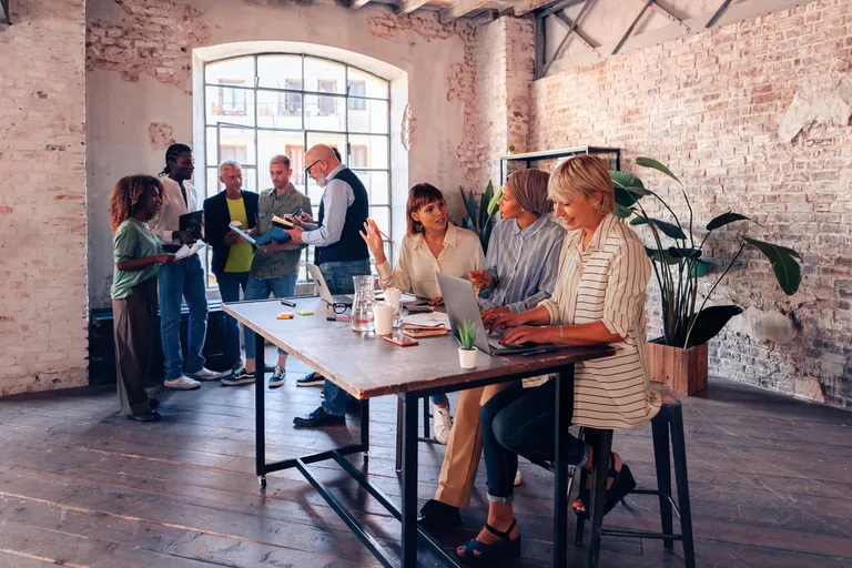 Crowd of employees collaborating on ideas and strategy