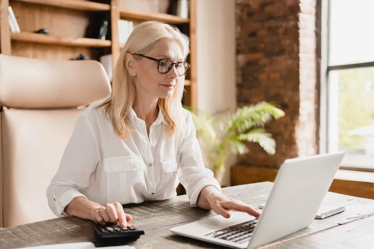 Advisor calculating funds with a calculator
