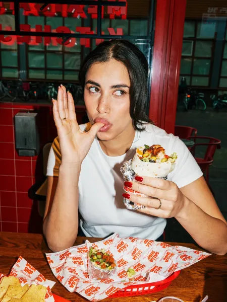 Guest enjoying a burrito at Salsa Shop
