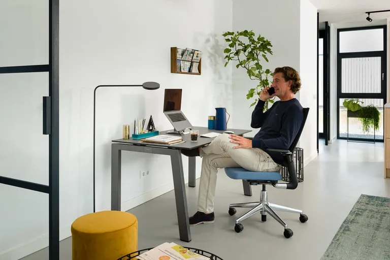 Remote worker on phone at home desk