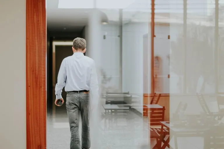 Man walking into empty office in the early morning
