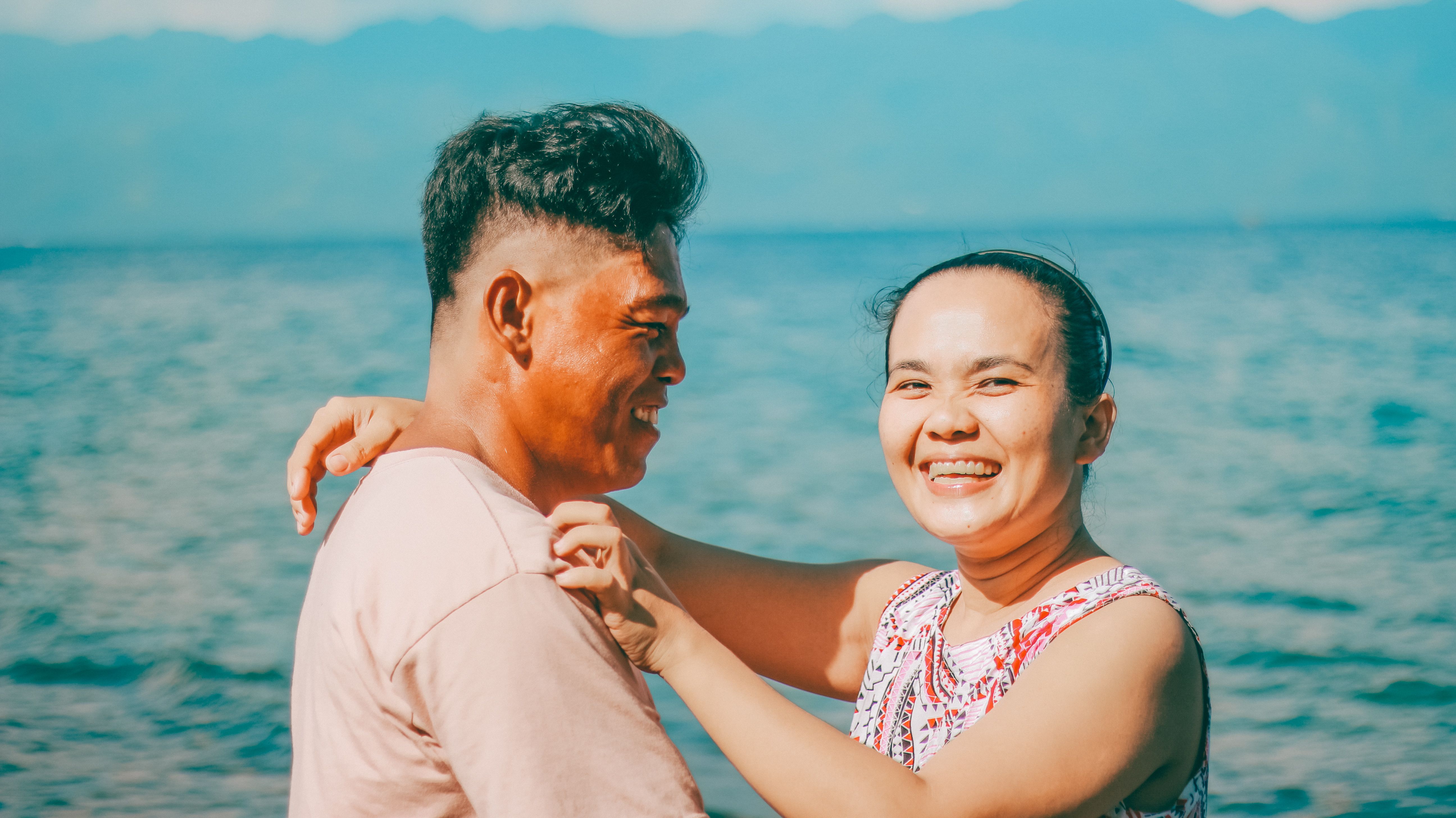 A happy asian couple laughing together 