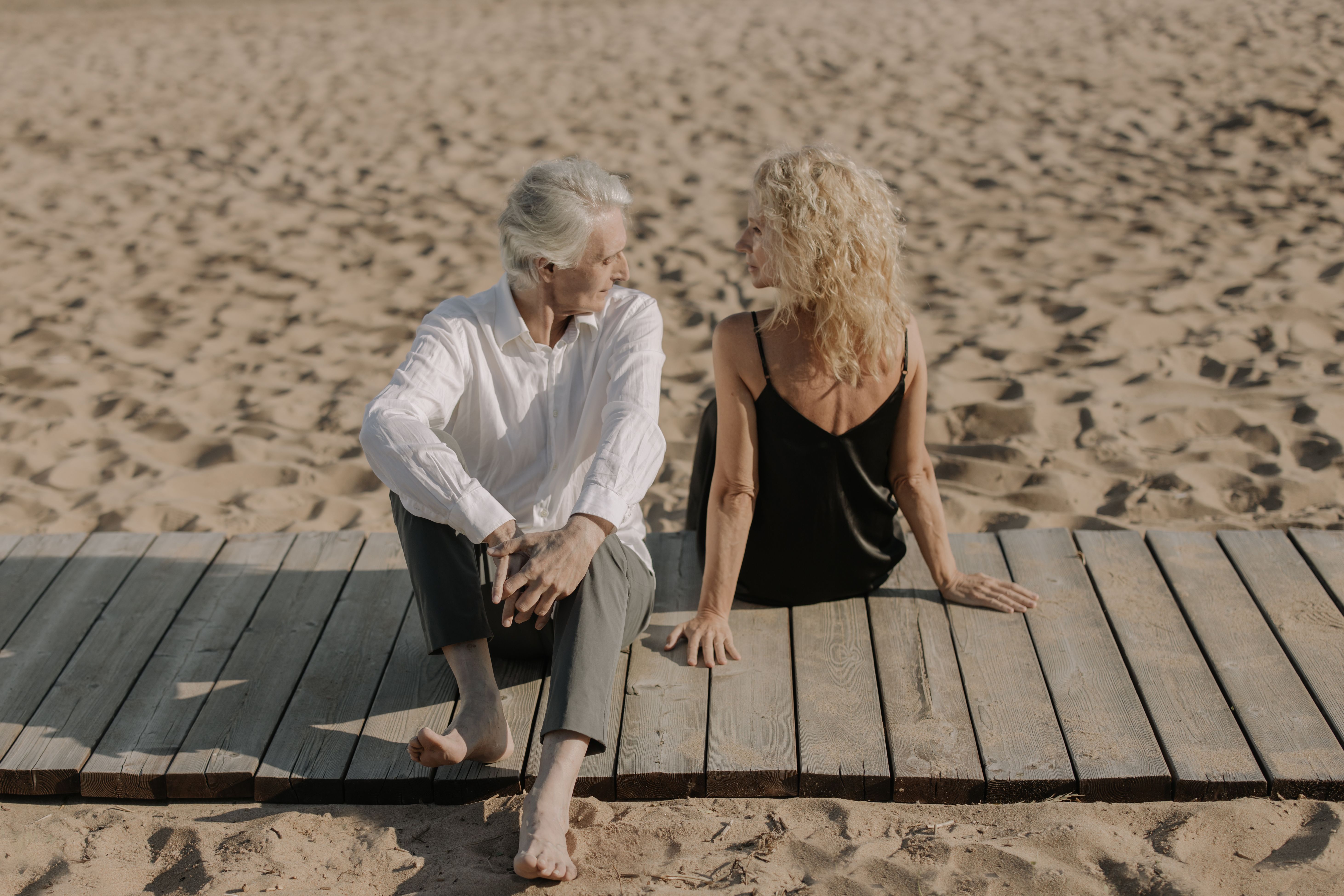 An older couple holds hands and looks at each