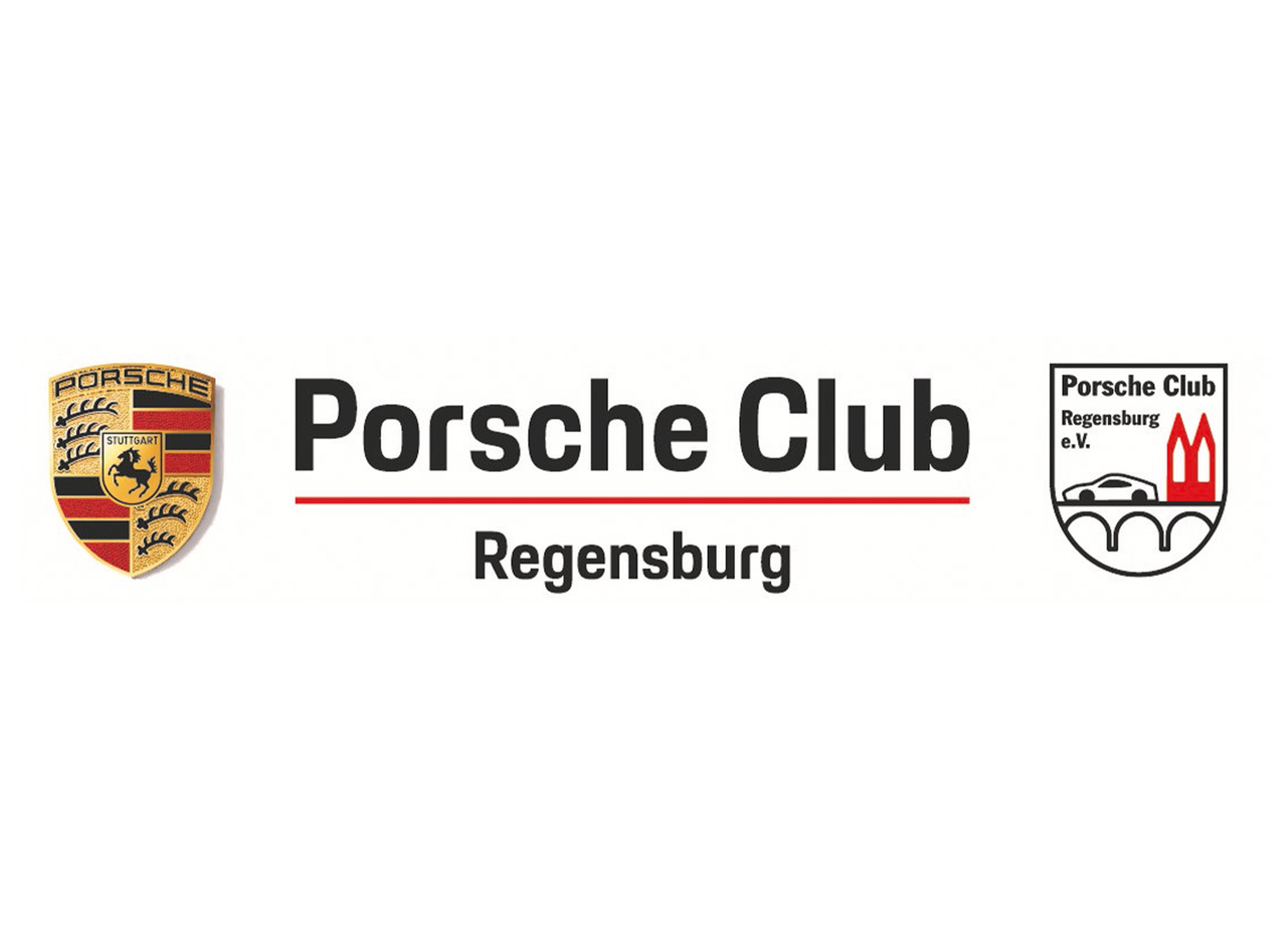 Mehrere Porsche fahren eine Serpentinenstraße entlang.