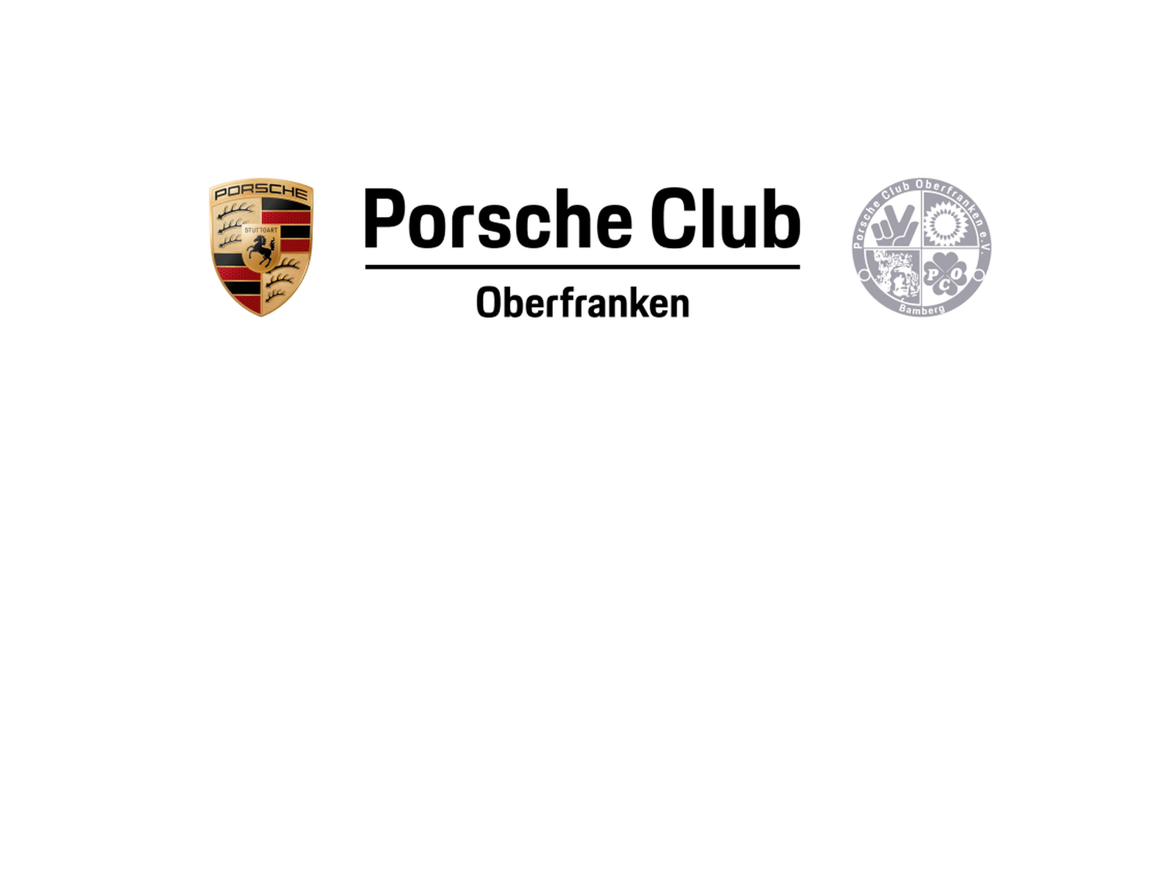 Mehrere Porsche fahren eine Serpentinenstraße entlang.