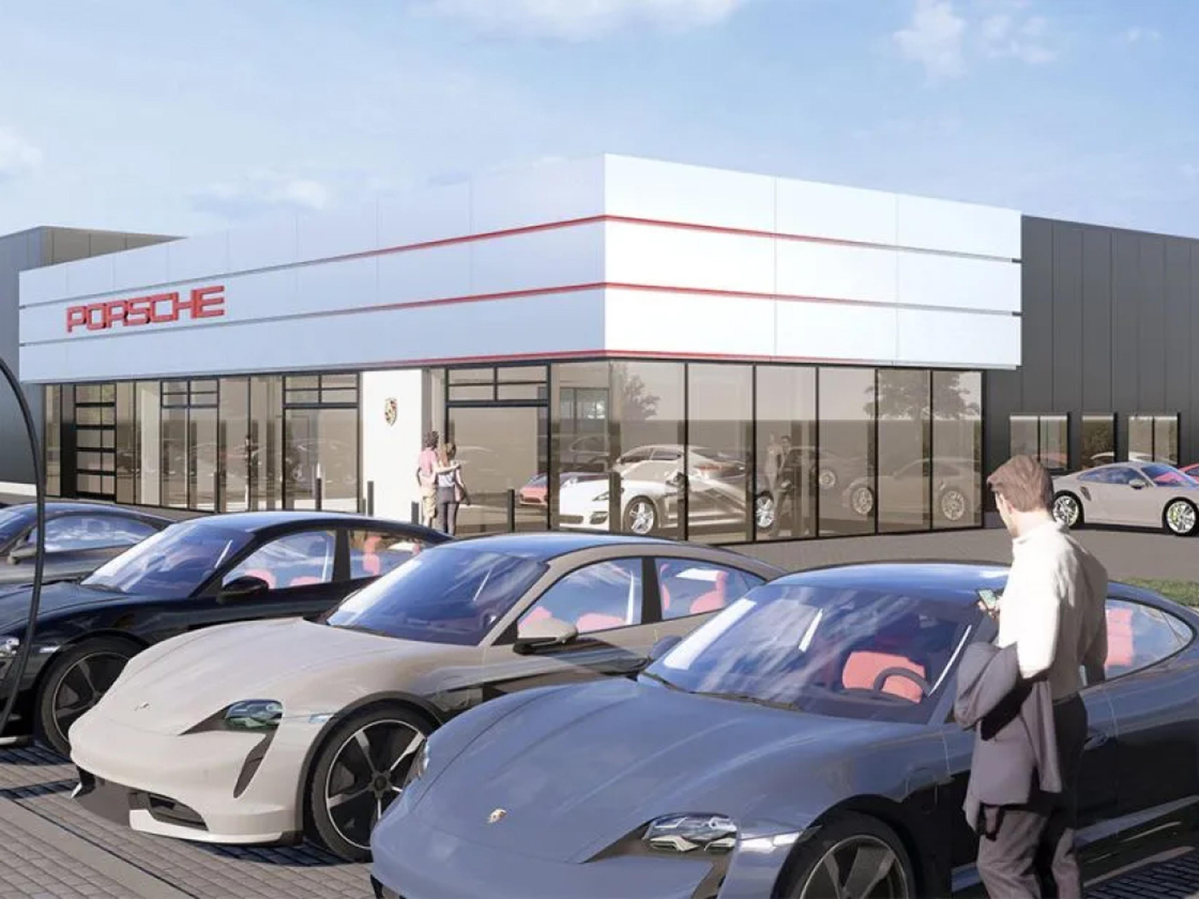Mehrere Porsche fahren eine Serpentinenstraße entlang.