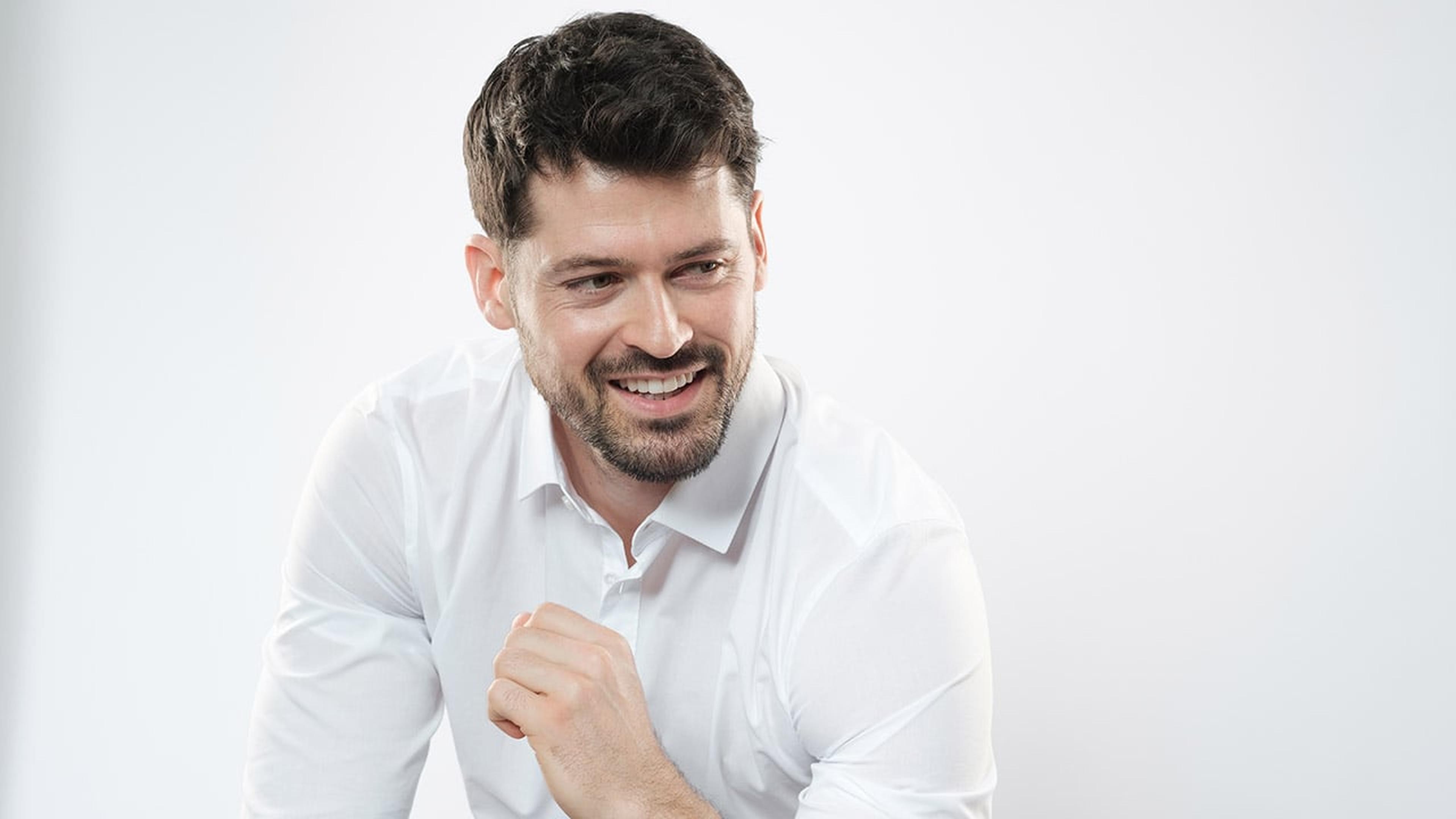 Florian Rudy lächelt zur Seite und ballt eine Faust.