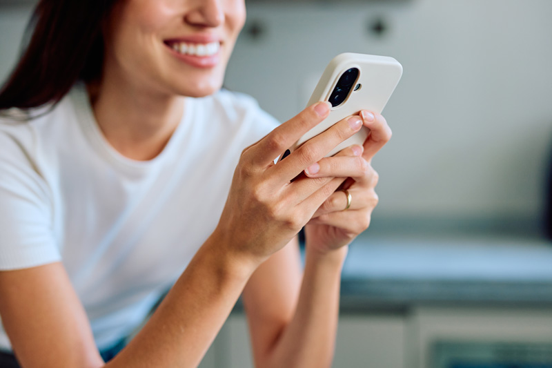 Junge Frau nutzt ihr Smartphone für digitale Information und Kommunikation.