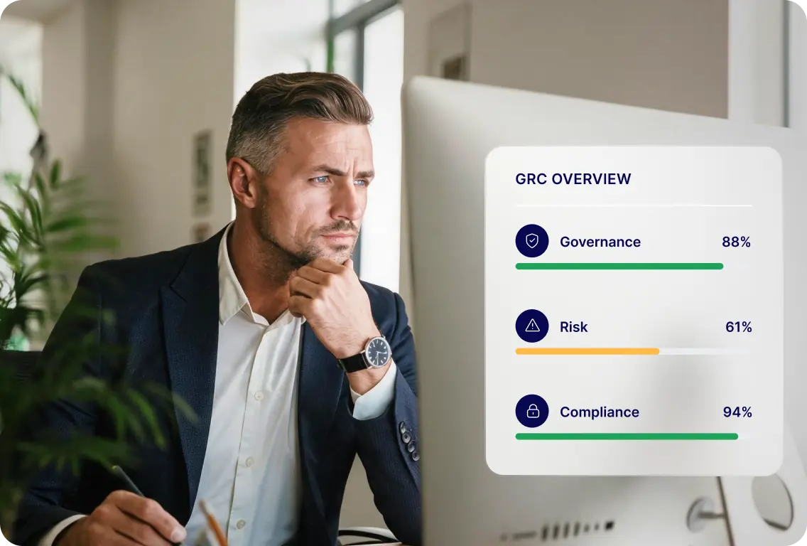 Professional reviewing a GRC dashboard showing governance, risk, and compliance metrics.