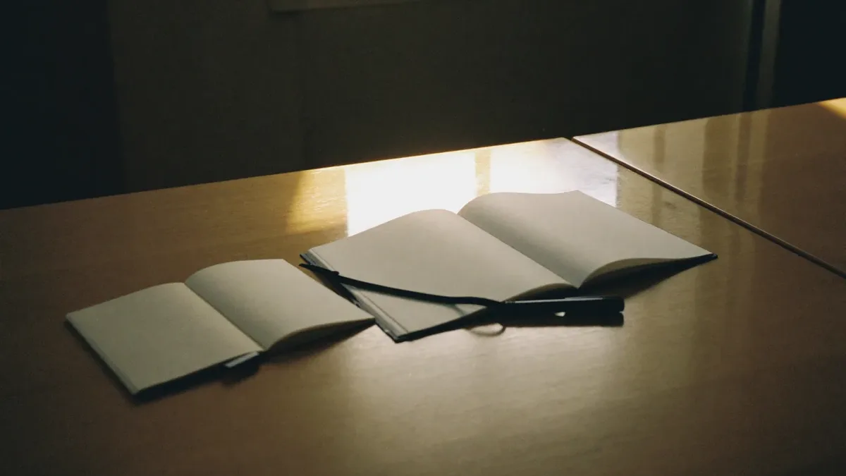 Notebook, pen and coffee on a meeting table during a Dubai marketing planning session