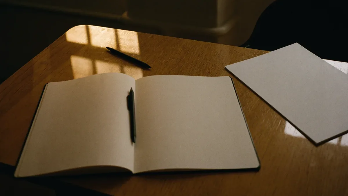 Notebook, pen and coffee on a meeting table during a Dubai marketing planning session