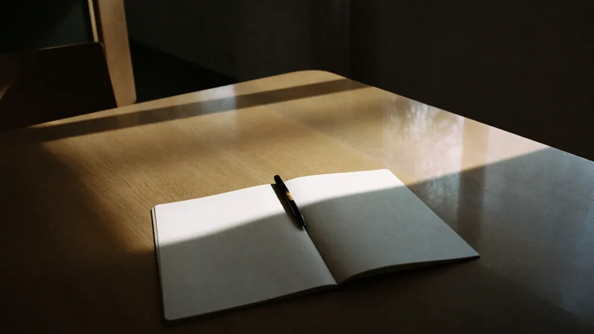 Notebook, pen and coffee on a meeting table during a Dubai marketing planning session