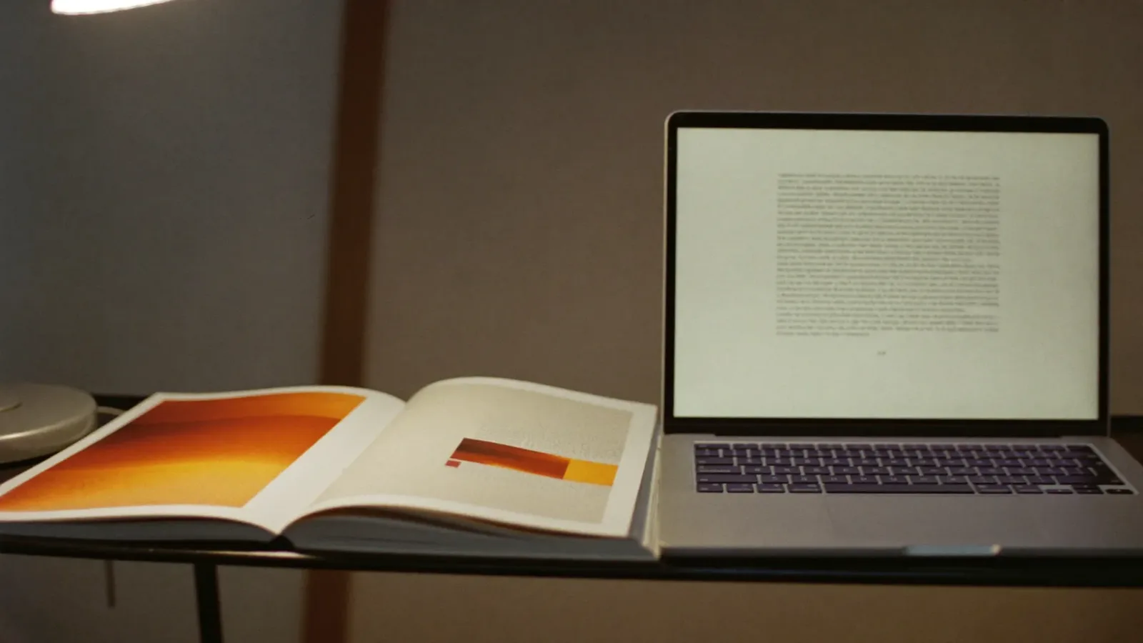 Desk with a printed manuscript covered in burnt orange editorial pen marks beside an open laptop showing a plain text — AI Content vs Human Content
