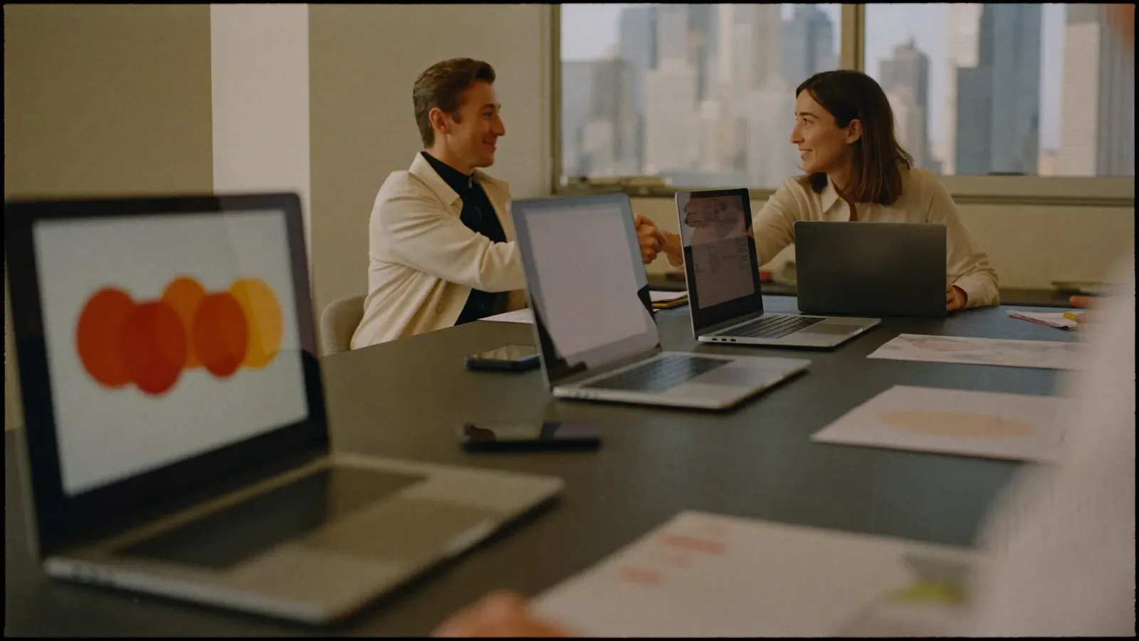 Two people shaking hands across a meeting table in a modern Dubai office — How to Choose a Digital Marketing Agency in Dubai