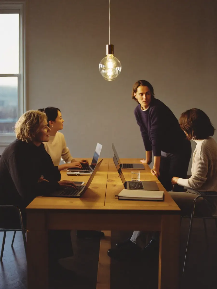 The Adnika team working together around a studio table