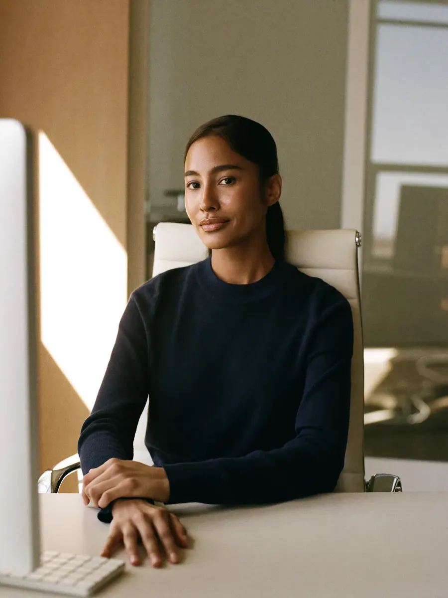 Financial services professional at a desk in a modern Dubai office