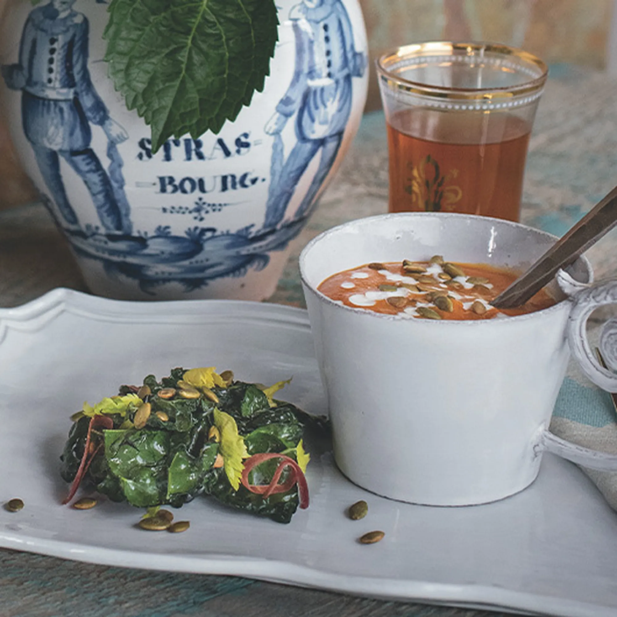A bowl of garden pumpkin soup with goat cheese crema and salted pepitas