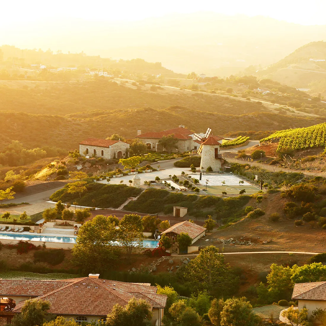 a landscape with houses and a pool