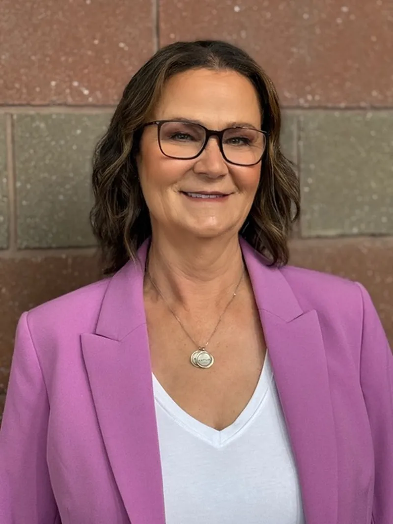 a woman in a pink suit