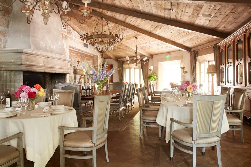 The Cal-a-Vie dining room set for a chef-prepared gourmet meal, warm light and Provençal table settings