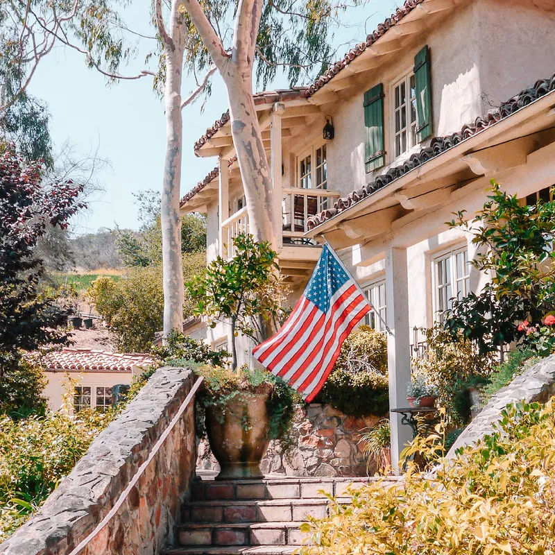 a flag from a staircase in front of a house