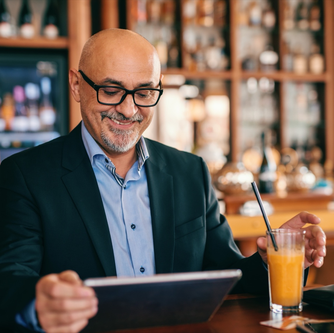Restaurant manager reviewing sales data on a tablet