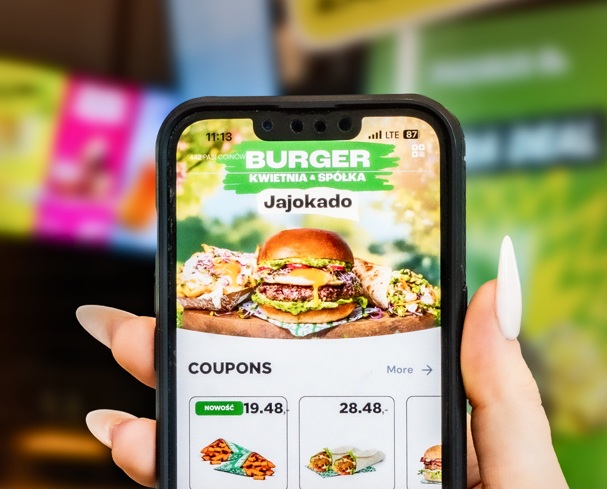 Hand holding a phone with a restaurant ordering app