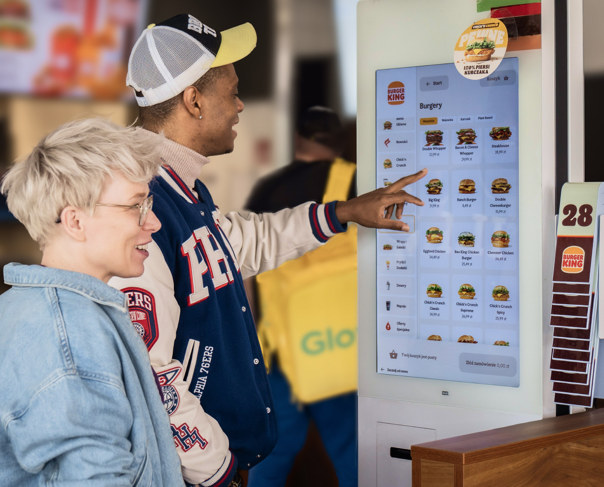 Guests choosing a meal on a self-service ordering kiosk
