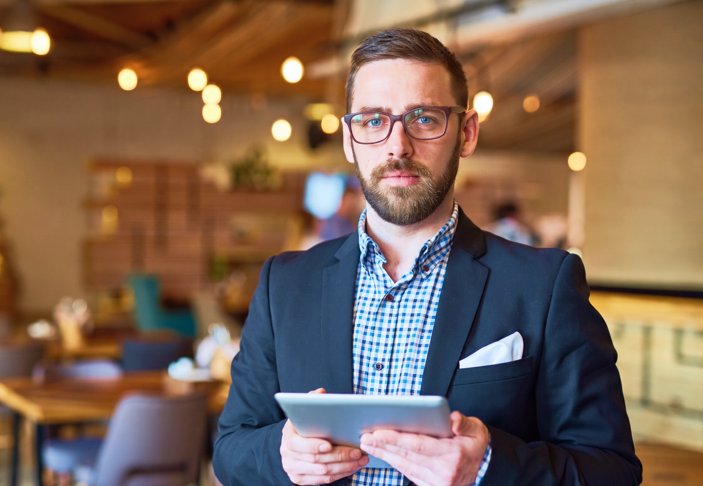 Restaurant manager holding a tablet in a quick-service restaurant