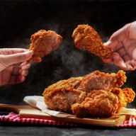 Fried chicken served on a wooden board